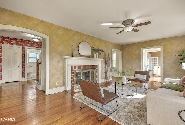 15497 Porterfield Hwy, Abingdon, VA 24210 - living area featuring arched walkways, wood finished floors, ceiling fan, and a fireplace
