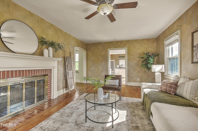 15497 Porterfield Hwy, Abingdon, VA 24210 - living area featuring wood finished floors, a ceiling fan, arched walkways, and a fireplace