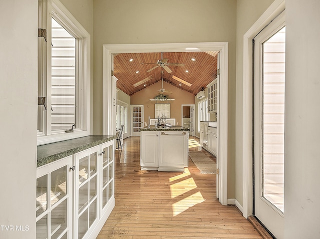 15497 Porterfield Hwy, Abingdon, VA 24210 - kitchen featuring wooden ceiling, dark countertops, vaulted ceiling, light wood finished floors, and glass insert cabinets
