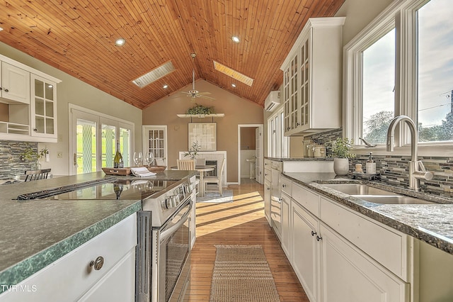 15497 Porterfield Hwy, Abingdon, VA 24210 - kitchen with stainless steel range with electric stovetop, ceiling fan, vaulted ceiling, wood ceiling, and tasteful backsplash