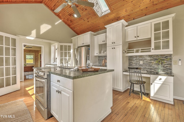15497 Porterfield Hwy, Abingdon, VA 24210 - kitchen featuring a ceiling fan, appliances with stainless steel finishes, dark countertops, light wood-style flooring, and wood ceiling