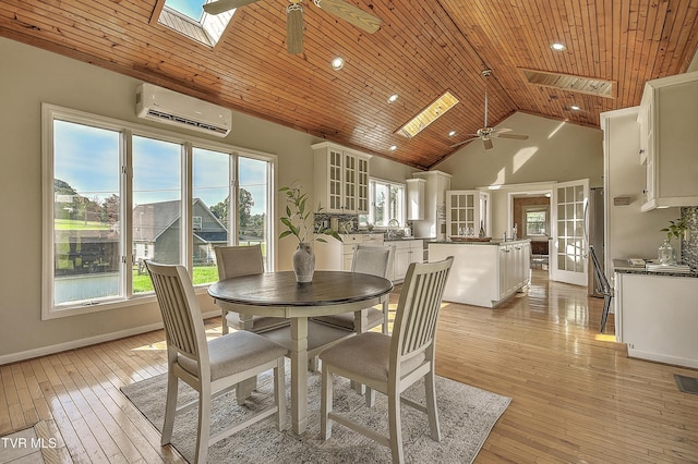 15497 Porterfield Hwy, Abingdon, VA 24210 - dining area with a ceiling fan, a skylight, a wall unit AC, wooden ceiling, and light wood-type flooring