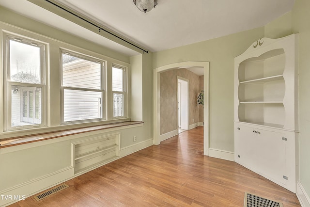 15497 Porterfield Hwy, Abingdon, VA 24210 - empty room with light wood finished floors and arched walkways
