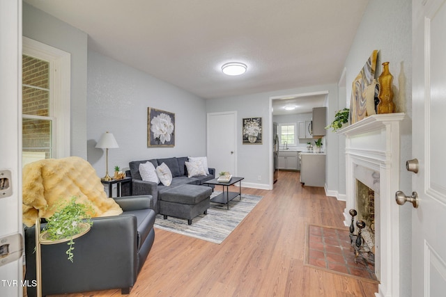3224 Clover St, Kingsport, TN 37664 - living area featuring light wood-style flooring, a fireplace with flush hearth, and baseboards