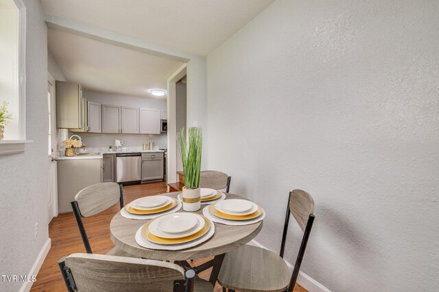 3224 Clover St, Kingsport, TN 37664 - dining space featuring light wood-style flooring, baseboards, and a textured wall
