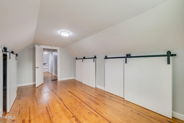 3224 Clover St, Kingsport, TN 37664 - bonus room with a barn door, light wood-style floors, vaulted ceiling, and baseboards
