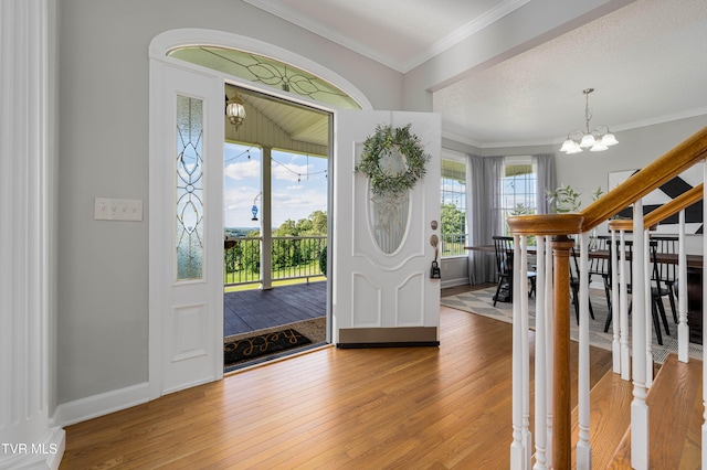 7540 Erwin Hwy, Chuckey, TN 37641 - foyer featuring a chandelier, light wood-type flooring, crown molding, and baseboards