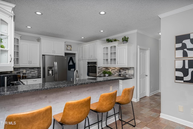 7540 Erwin Hwy, Chuckey, TN 37641 - kitchen with appliances with stainless steel finishes, baseboards, glass insert cabinets, a breakfast bar, and decorative backsplash