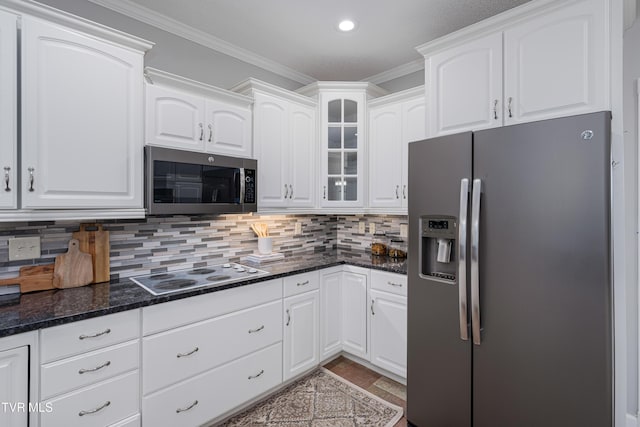 7540 Erwin Hwy, Chuckey, TN 37641 - kitchen featuring appliances with stainless steel finishes, glass insert cabinets, white cabinetry, ornamental molding, and backsplash