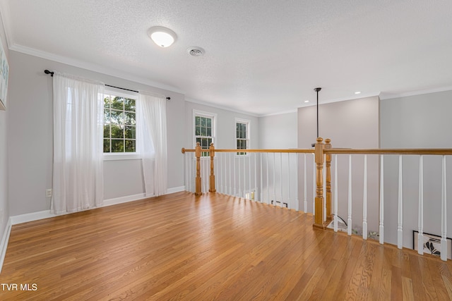 7540 Erwin Hwy, Chuckey, TN 37641 - empty room featuring hardwood / wood-style flooring, crown molding, a textured ceiling, and baseboards