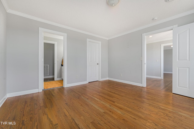 7540 Erwin Hwy, Chuckey, TN 37641 - unfurnished bedroom with baseboards, ornamental molding, wood finished floors, ensuite bathroom, and a closet