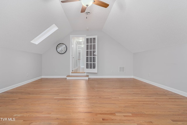 7540 Erwin Hwy, Chuckey, TN 37641 - additional living space featuring a skylight, ceiling fan, a textured ceiling, vaulted ceiling, and light wood-style floors