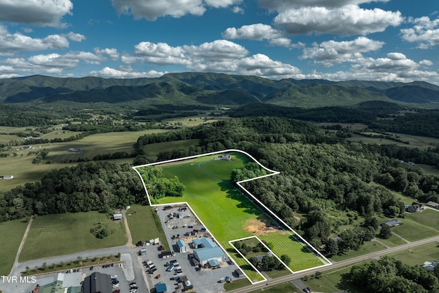 7540 Erwin Hwy, Chuckey, TN 37641 - aerial view of property and surrounding area featuring property boundaries highlighted, a mountain backdrop, and a forest