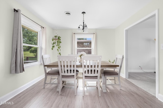 405 Castaway Dr, Kingsport, TN 37663 - dining space with baseboards, light wood-style flooring, and a chandelier