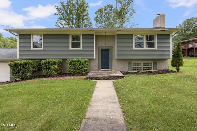 405 Castaway Dr, Kingsport, TN 37663 - raised ranch featuring a chimney, a front lawn, brick siding, and an attached garage