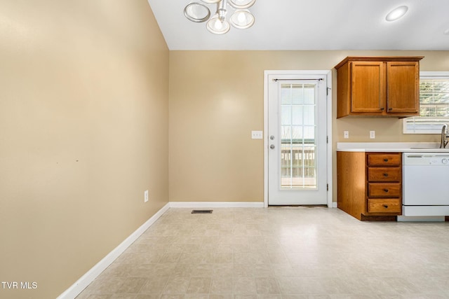 1213 American Way, Jonesborough, TN 37659 - kitchen featuring white dishwasher, brown cabinets, a chandelier, light countertops, and baseboards