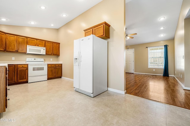 1213 American Way, Jonesborough, TN 37659 - kitchen with white appliances, brown cabinets, ceiling fan, light countertops, and baseboards