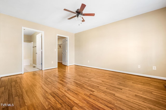 1213 American Way, Jonesborough, TN 37659 - unfurnished bedroom featuring light wood finished floors, baseboards, a walk in closet, and connected bathroom