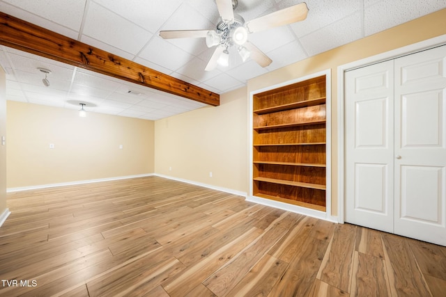 1213 American Way, Jonesborough, TN 37659 - finished basement with baseboards, light wood-type flooring, a ceiling fan, built in features, and a paneled ceiling