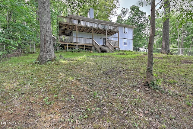 back of house with a wooden deck and stairs