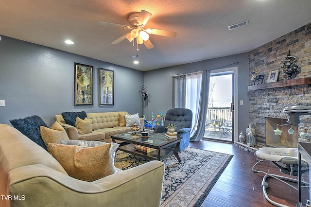 living area with a ceiling fan, hardwood / wood-style floors, a textured ceiling, and recessed lighting