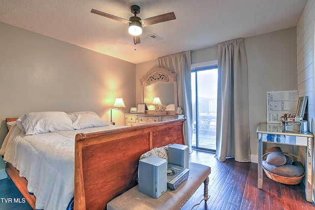 bedroom with dark wood-style floors, access to outside, and ceiling fan
