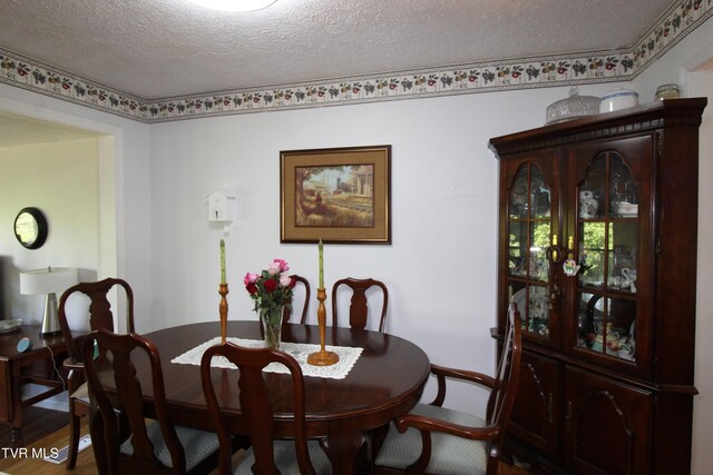 16319 Mary St, Abingdon, VA 24210 - dining room with a textured ceiling, baseboards, and wood finished floors