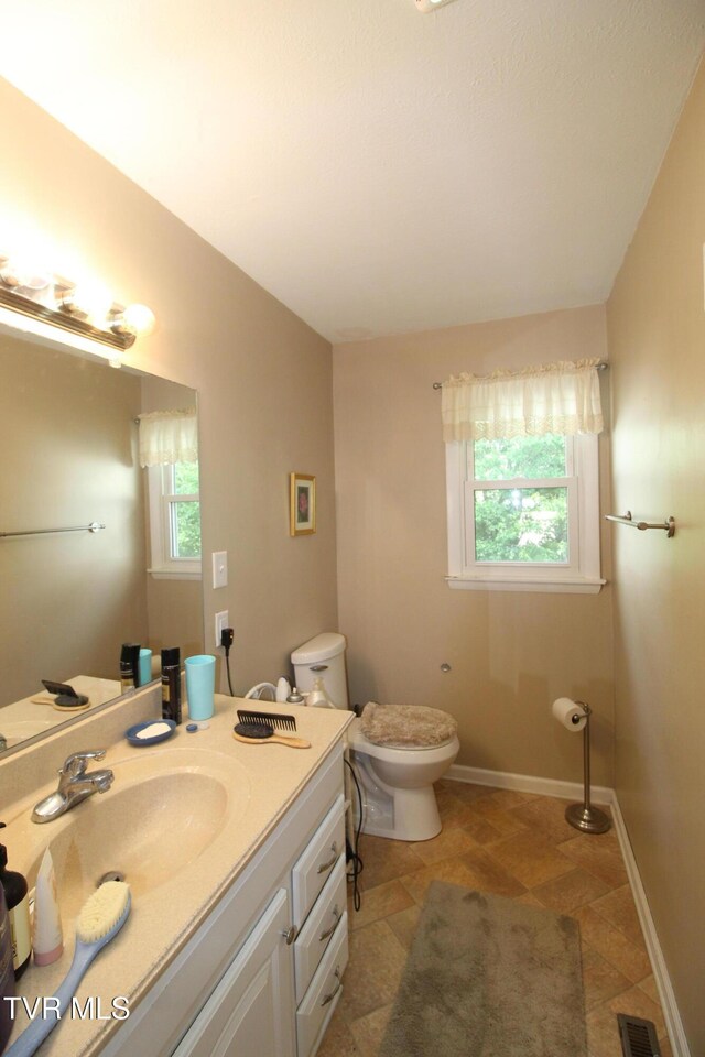 16319 Mary St, Abingdon, VA 24210 - bathroom featuring plenty of natural light, toilet, vanity, and baseboards