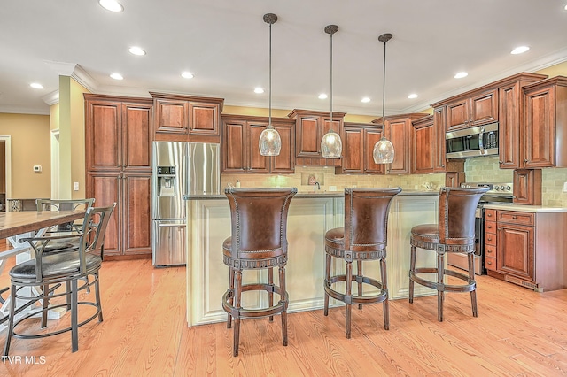 2041 King College Rd, Bristol, TN 37620 - kitchen featuring stainless steel appliances, ornamental molding, light wood-style flooring, a breakfast bar area, and pendant lighting