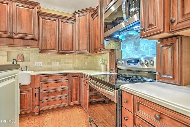 2041 King College Rd, Bristol, TN 37620 - kitchen featuring stainless steel appliances, light wood-type flooring, light countertops, and brown cabinets