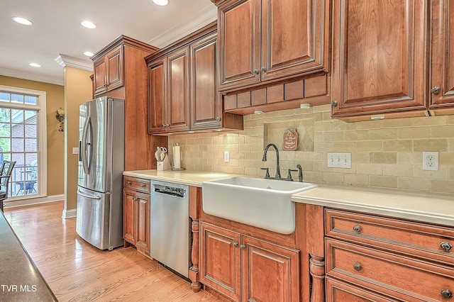 2041 King College Rd, Bristol, TN 37620 - kitchen featuring stainless steel appliances, a sink, ornamental molding, light wood-style floors, and backsplash