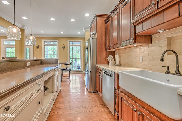 2041 King College Rd, Bristol, TN 37620 - kitchen featuring appliances with stainless steel finishes, a sink, ornamental molding, light wood-type flooring, and pendant lighting