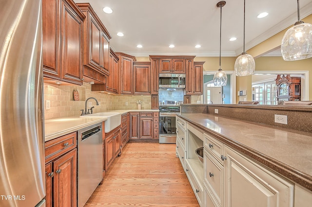 2041 King College Rd, Bristol, TN 37620 - kitchen with appliances with stainless steel finishes, a sink, crown molding, light wood-style floors, and decorative light fixtures