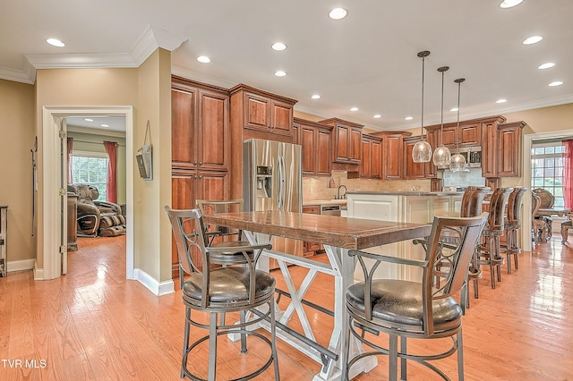 2041 King College Rd, Bristol, TN 37620 - kitchen featuring ornamental molding, light wood-type flooring, healthy amount of natural light, brown cabinetry, and recessed lighting