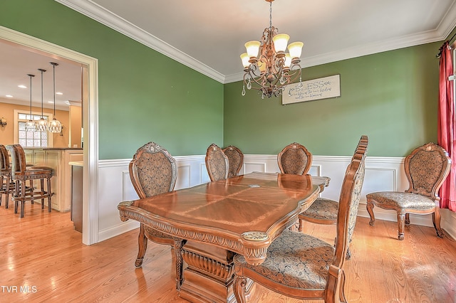 2041 King College Rd, Bristol, TN 37620 - dining area featuring a chandelier, light wood-type flooring, crown molding, and wainscoting