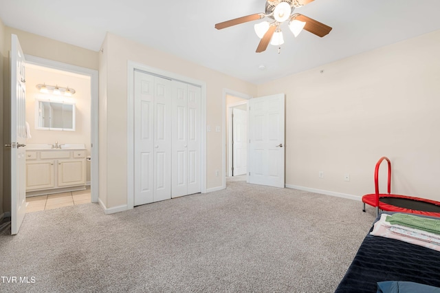 614 N Center St Unit 5, Johnson City, TN 37604 - unfurnished bedroom with light carpet, baseboards, a sink, and a closet