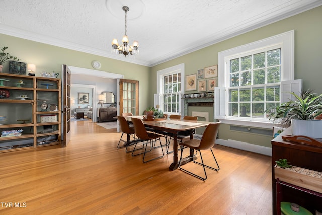 2107 Bartlett St, Johnson City, TN 37601 - dining room with ornamental molding, a textured ceiling, light wood finished floors, and a chandelier