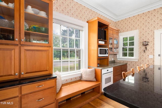 2107 Bartlett St, Johnson City, TN 37601 - kitchen featuring wallpapered walls, white appliances, plenty of natural light, crown molding, and glass insert cabinets