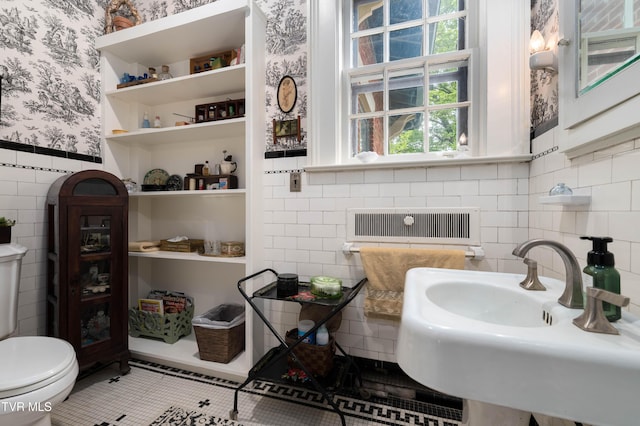 2107 Bartlett St, Johnson City, TN 37601 - bathroom with wallpapered walls, tile walls, a sink, toilet, and a wainscoted wall