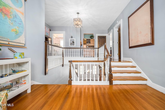 2107 Bartlett St, Johnson City, TN 37601 - stairs with a chandelier, baseboards, and wood finished floors