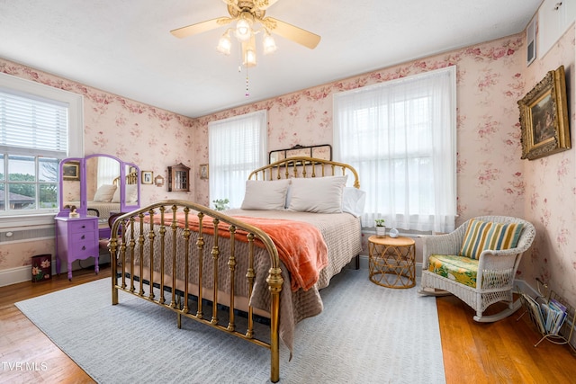 2107 Bartlett St, Johnson City, TN 37601 - bedroom with wood finished floors, wallpapered walls, and ceiling fan