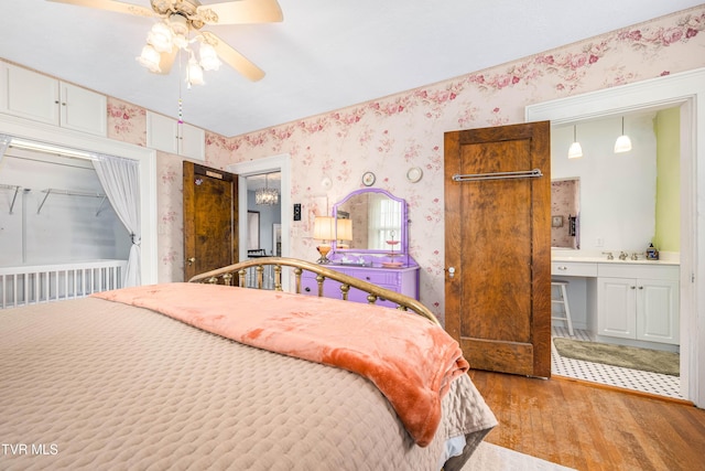 2107 Bartlett St, Johnson City, TN 37601 - bedroom featuring light wood-style floors, wallpapered walls, a sink, and connected bathroom