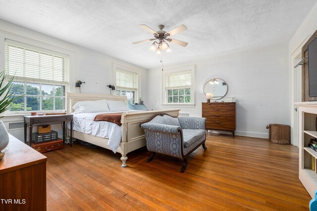 2107 Bartlett St, Johnson City, TN 37601 - bedroom featuring wood finished floors, a textured ceiling, baseboards, and a ceiling fan