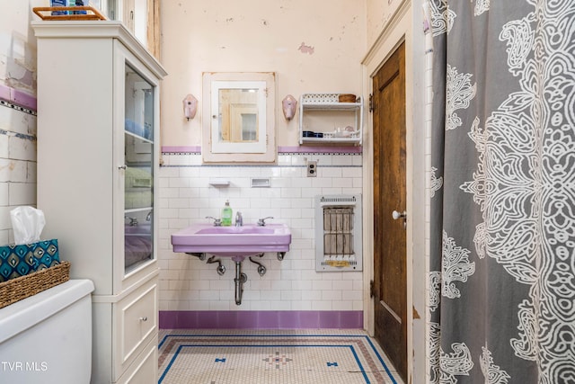 2107 Bartlett St, Johnson City, TN 37601 - full bathroom featuring toilet, a sink, tile patterned flooring, tile walls, and wainscoting