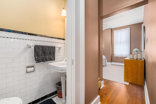 2107 Bartlett St, Johnson City, TN 37601 - half bathroom featuring tile walls, wood finished floors, and toilet