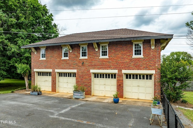 2107 Bartlett St, Johnson City, TN 37601 - view of front facade with brick siding, roof with shingles, and a detached garage