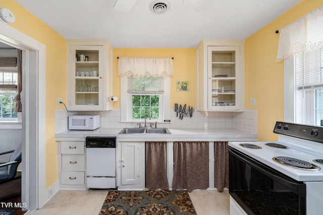 2107 Bartlett St, Johnson City, TN 37601 - kitchen featuring white appliances, a sink, decorative backsplash, and a ceiling fan