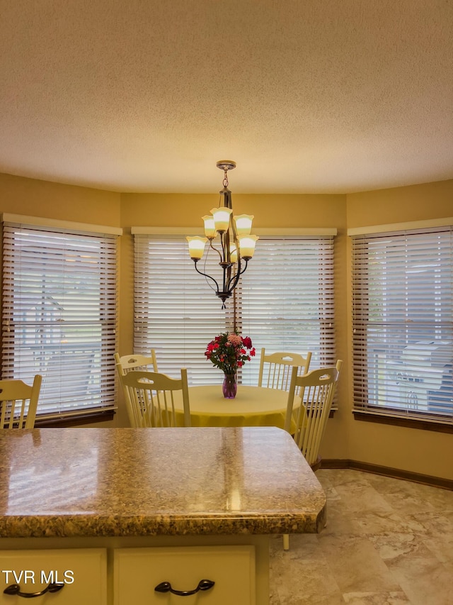 519 Foxgate Dr, Erwin, TN 37650 - dining area with a chandelier, a textured ceiling, healthy amount of natural light, and baseboards