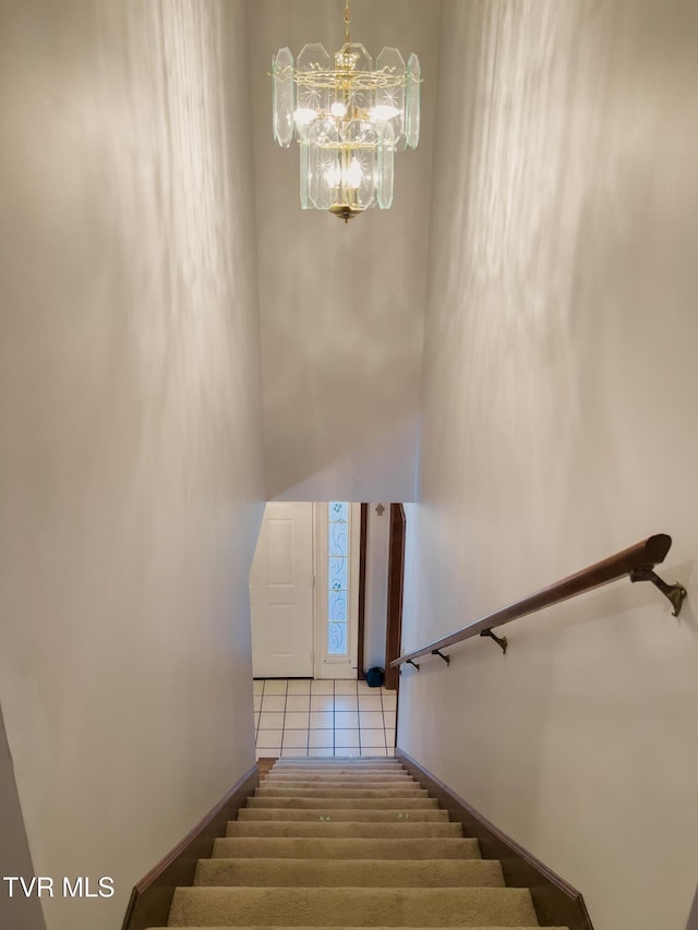 519 Foxgate Dr, Erwin, TN 37650 - staircase featuring a chandelier, a high ceiling, tile patterned flooring, and baseboards