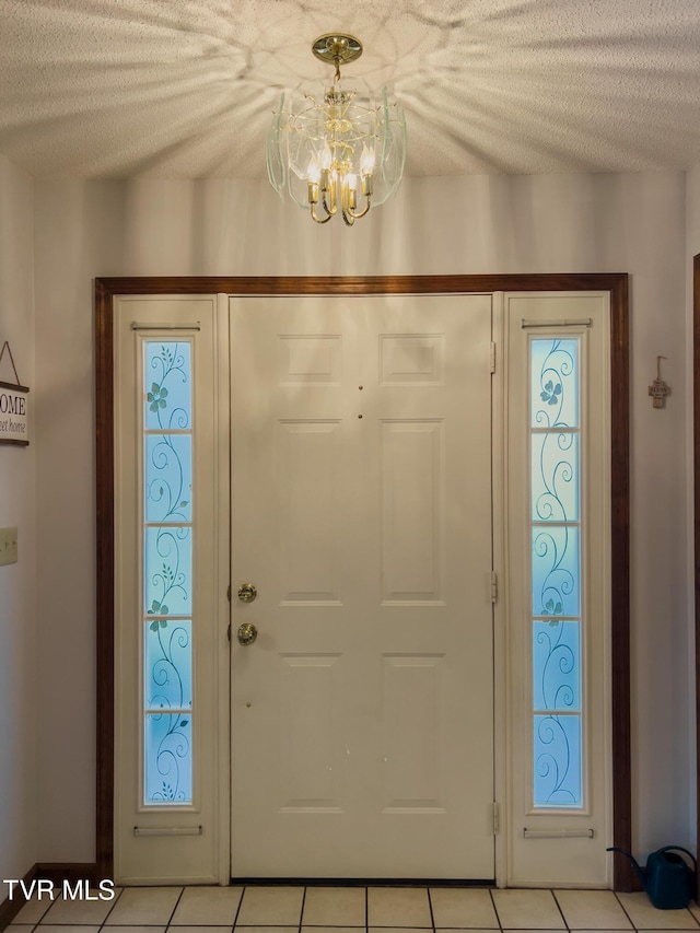 519 Foxgate Dr, Erwin, TN 37650 - entryway with a chandelier, light tile patterned floors, and a textured ceiling